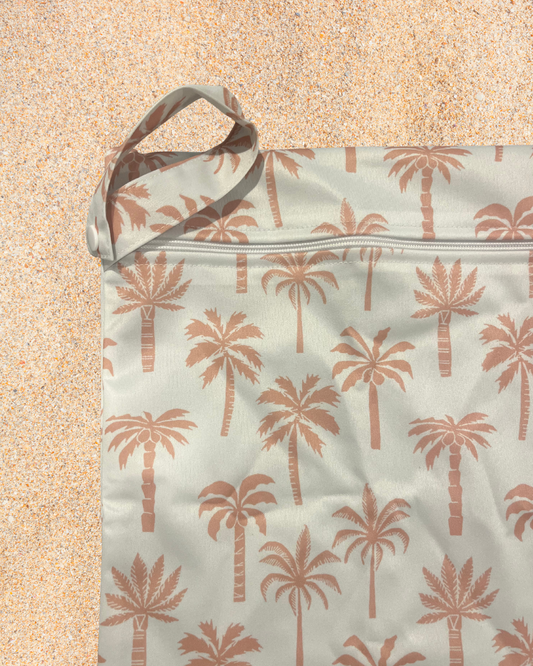Bag with palm tree pattern on a sandy background