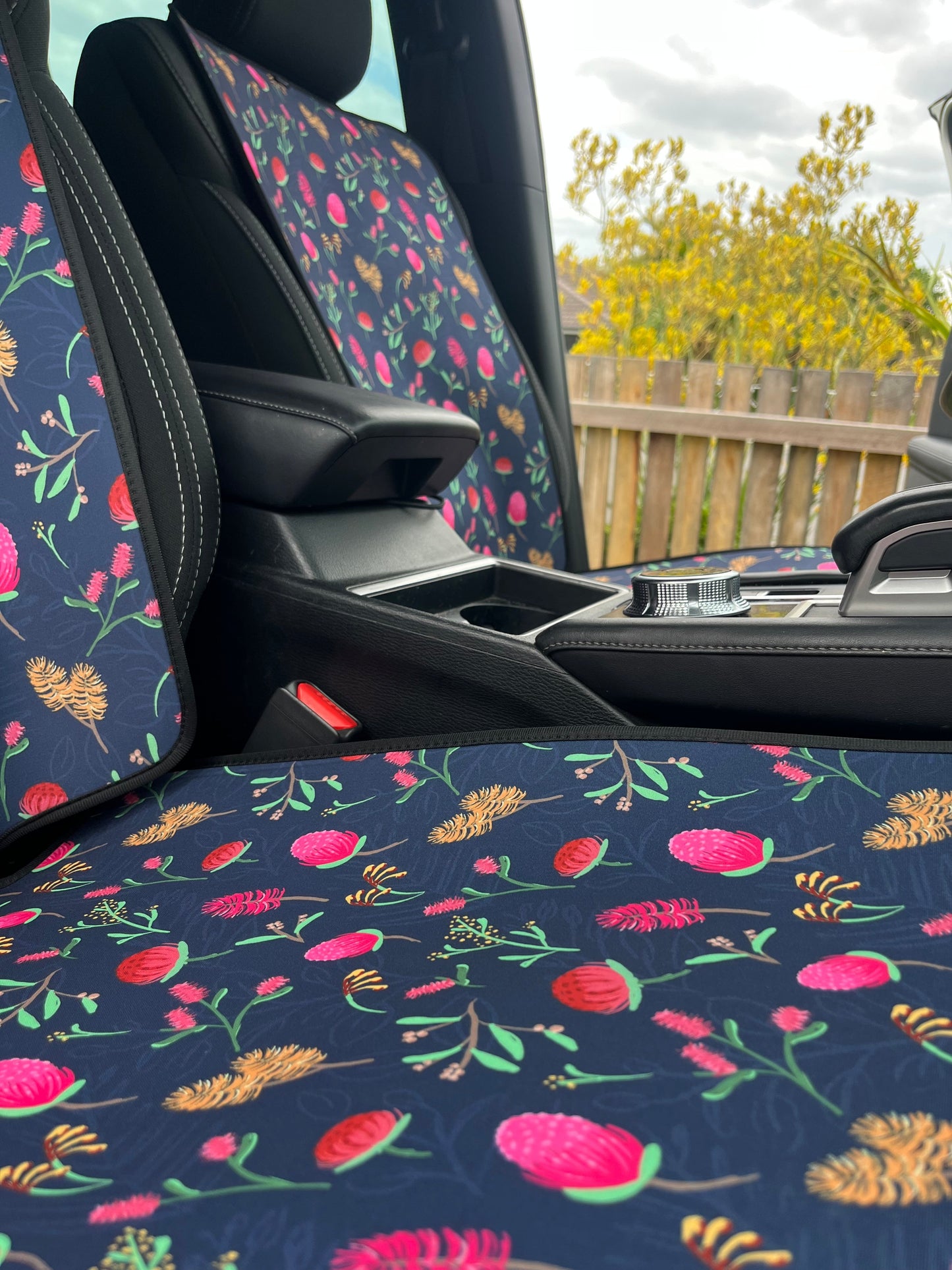 Floral-patterned car seat cover with a visible car interior background