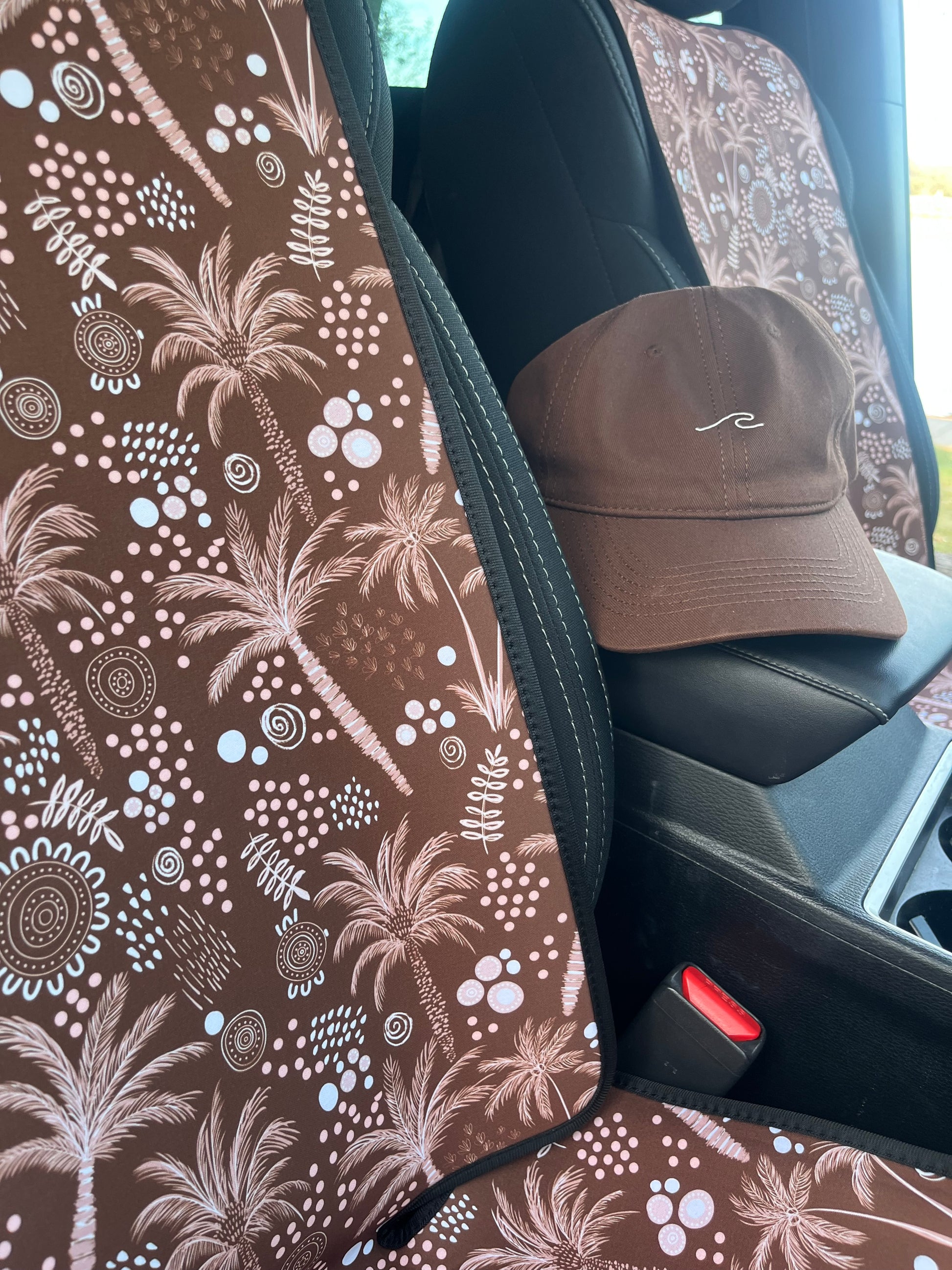 Pet car seat cover with brown palms and indigenous art