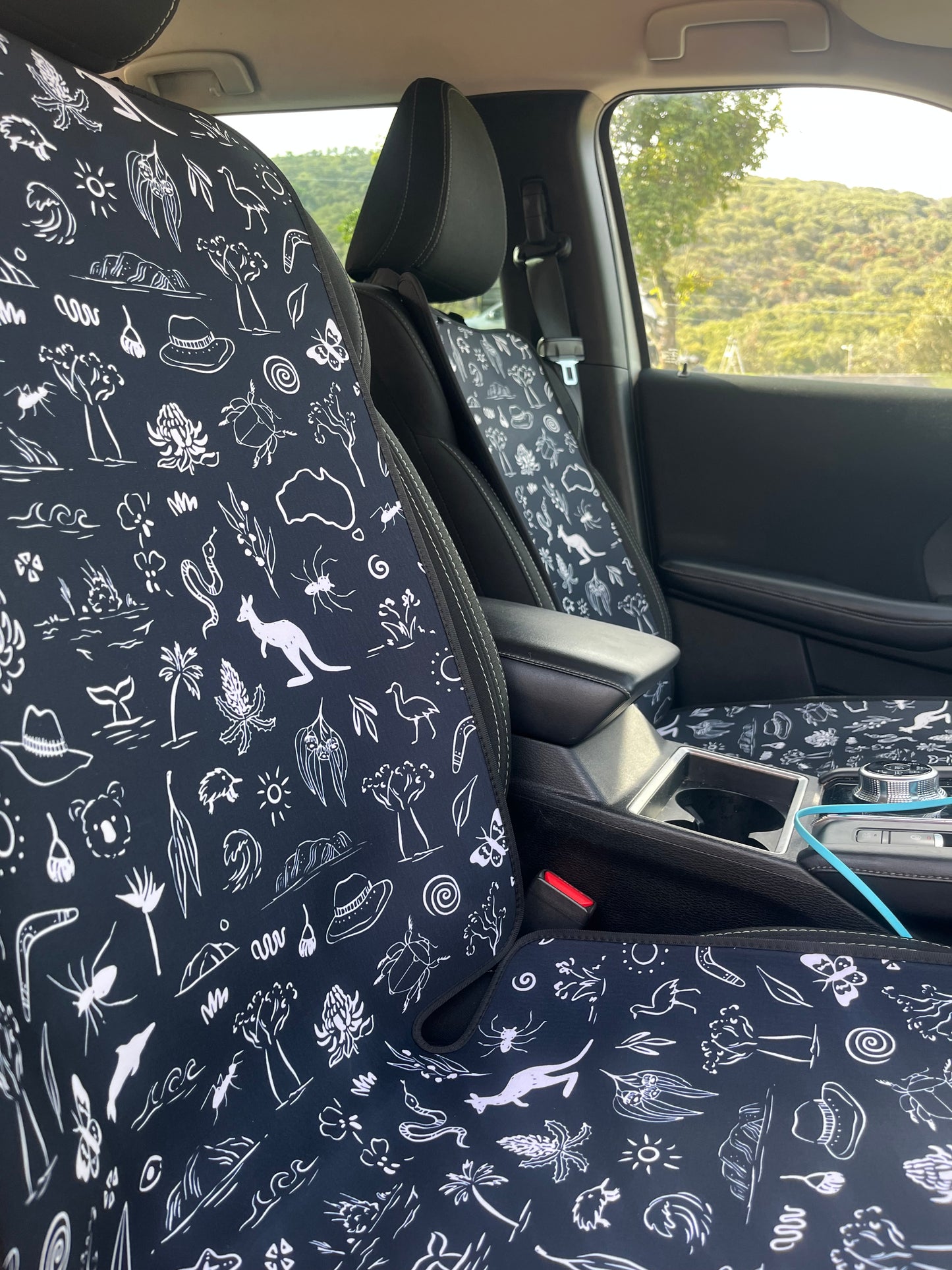 Car interior with patterned black and white seat covers. Aussie animal 