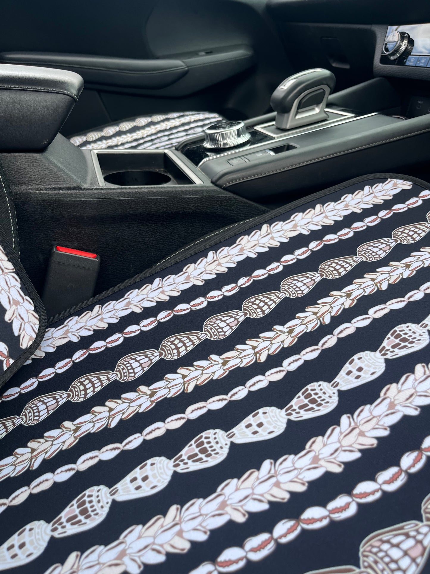 Seashell Lei patterned Car Seat Covers in the car. Black and white in colour