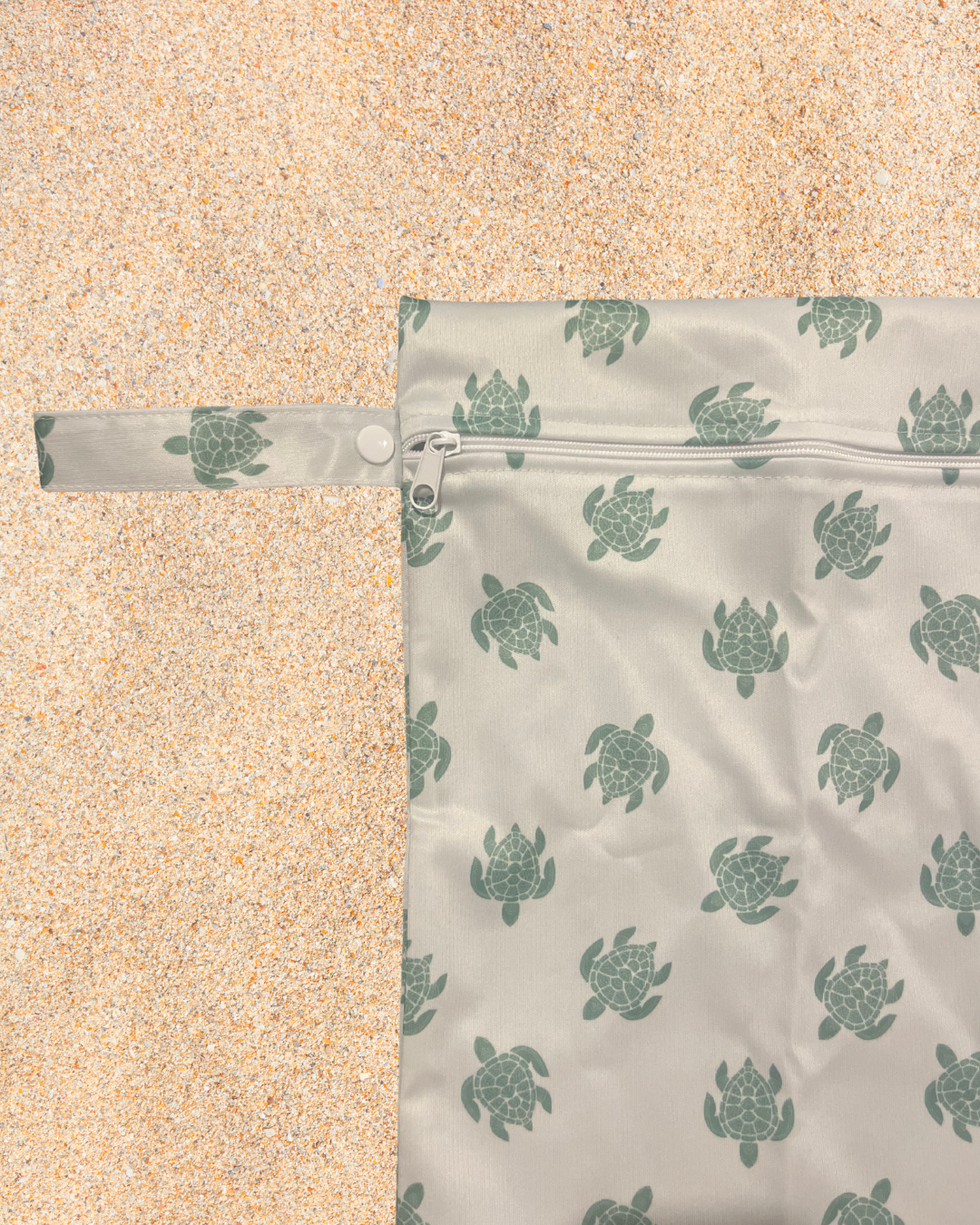 Reusable bag with turtle pattern on a sandy background