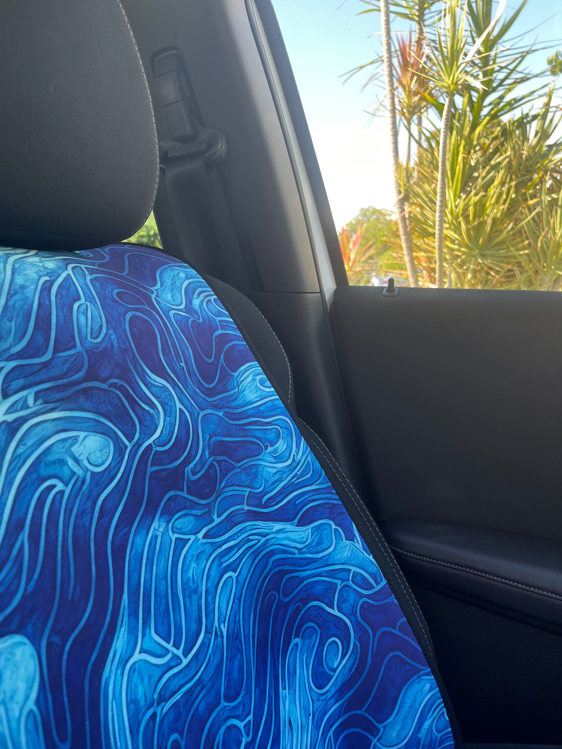 Set of bright blue ocean inspired waterproof Car Seat Covers. Made out of neoprene. Blue tie dye style print that resembles the oceans waves