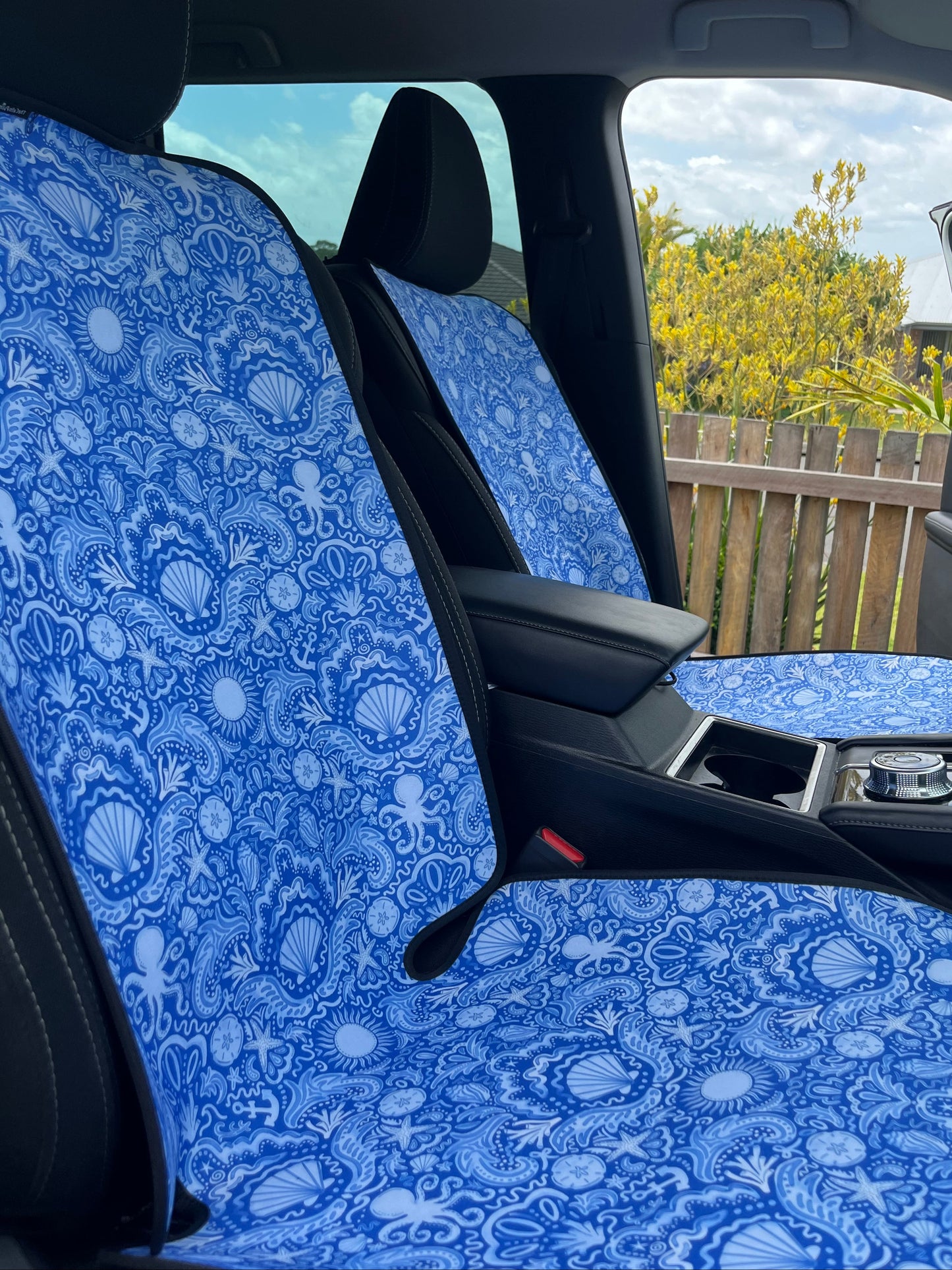 Car interior with blue patterned headliner and side window
