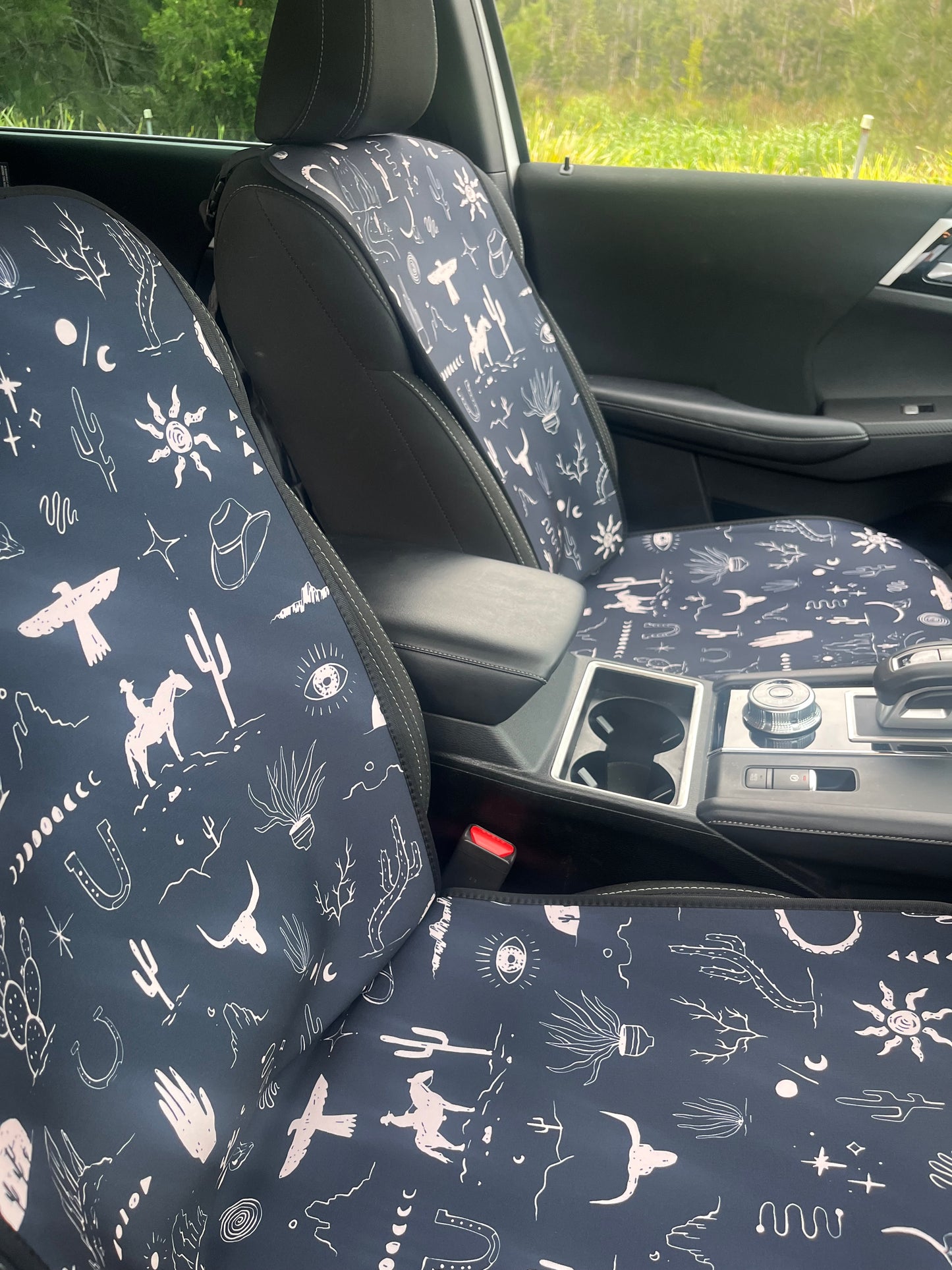 Set of black and white cowboy print Car Seat Cover shown on front car seats