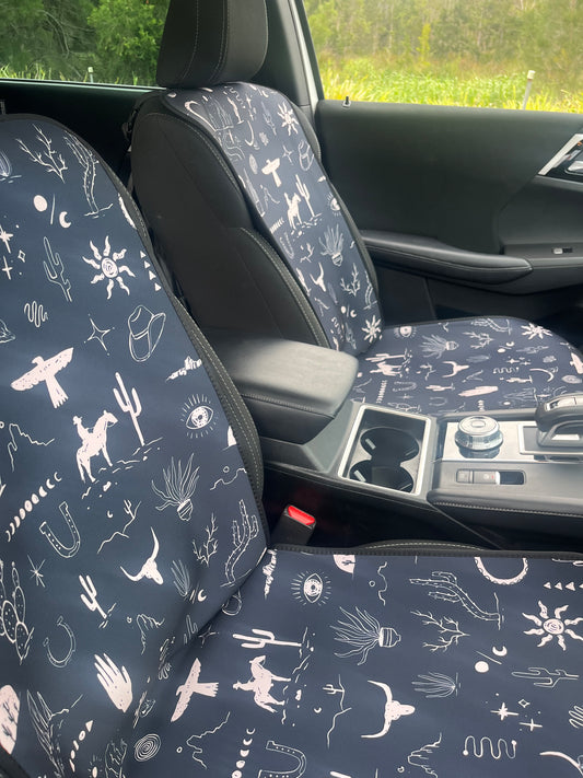 Set of black and white cowboy print Car Seat Cover shown on front car seats