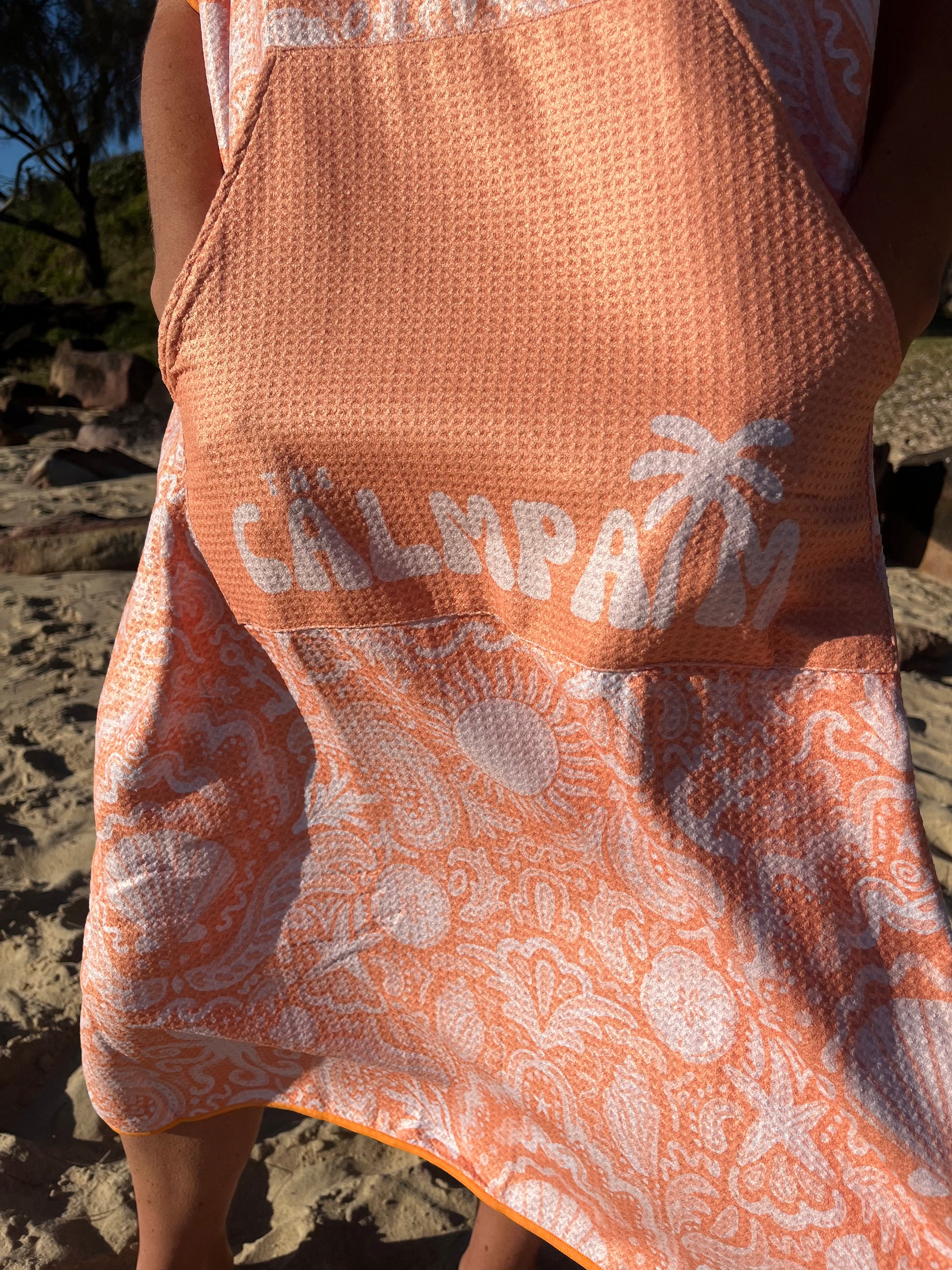 Close-up of a hooded beach towel. Orange sheels