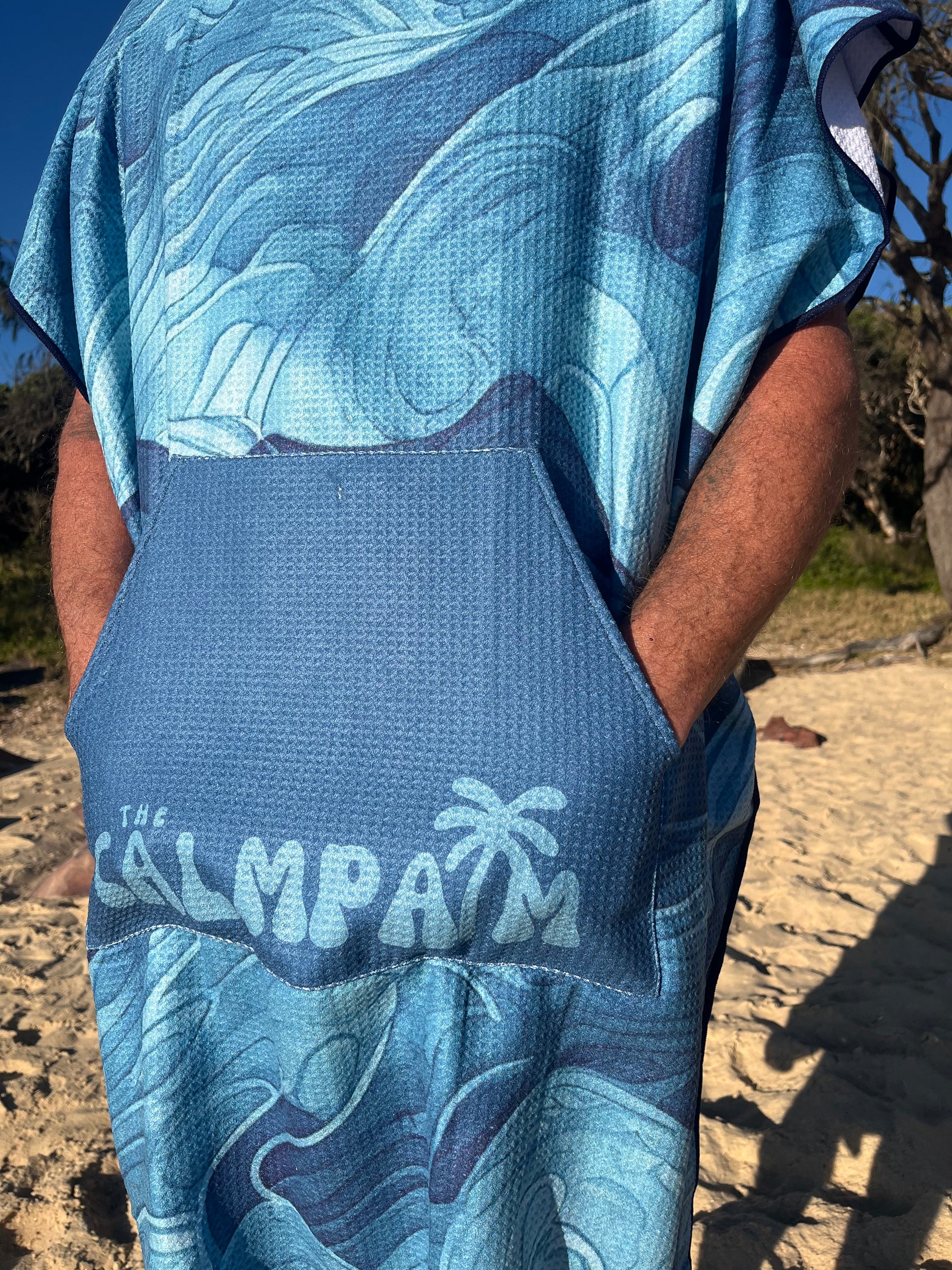 close up blue ocean hooded beach towel on man on the beach