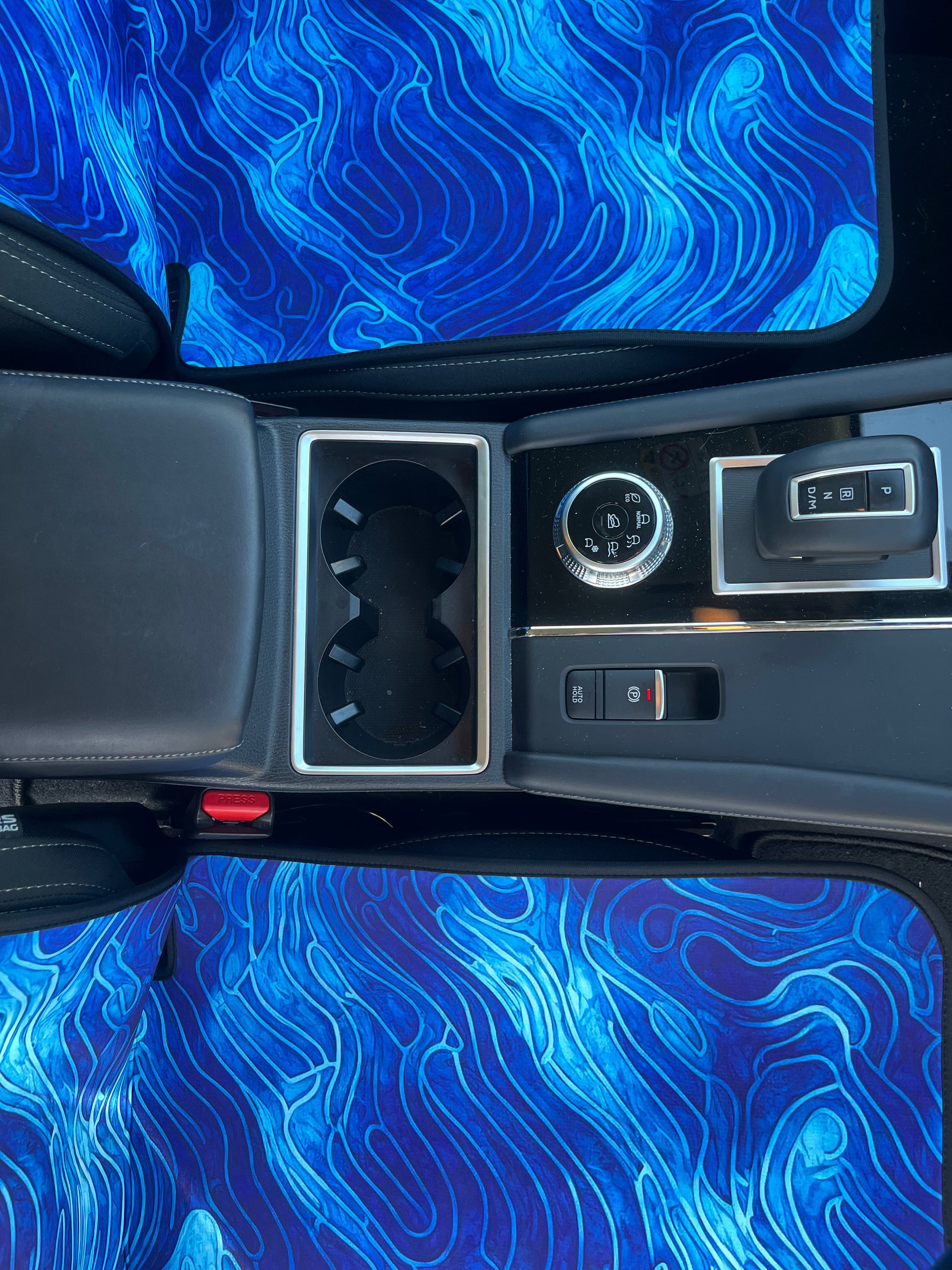 Set of bright blue ocean inspired waterproof Car Seat Covers. Made out of neoprene. Blue tie dye style print that resembles the oceans waves. Base view of covers where you sit