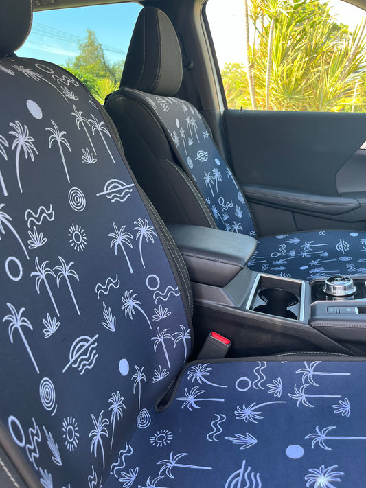Black and white Palm tree print. Set of Seat Covers shown on the front seats of a car. Easy to install