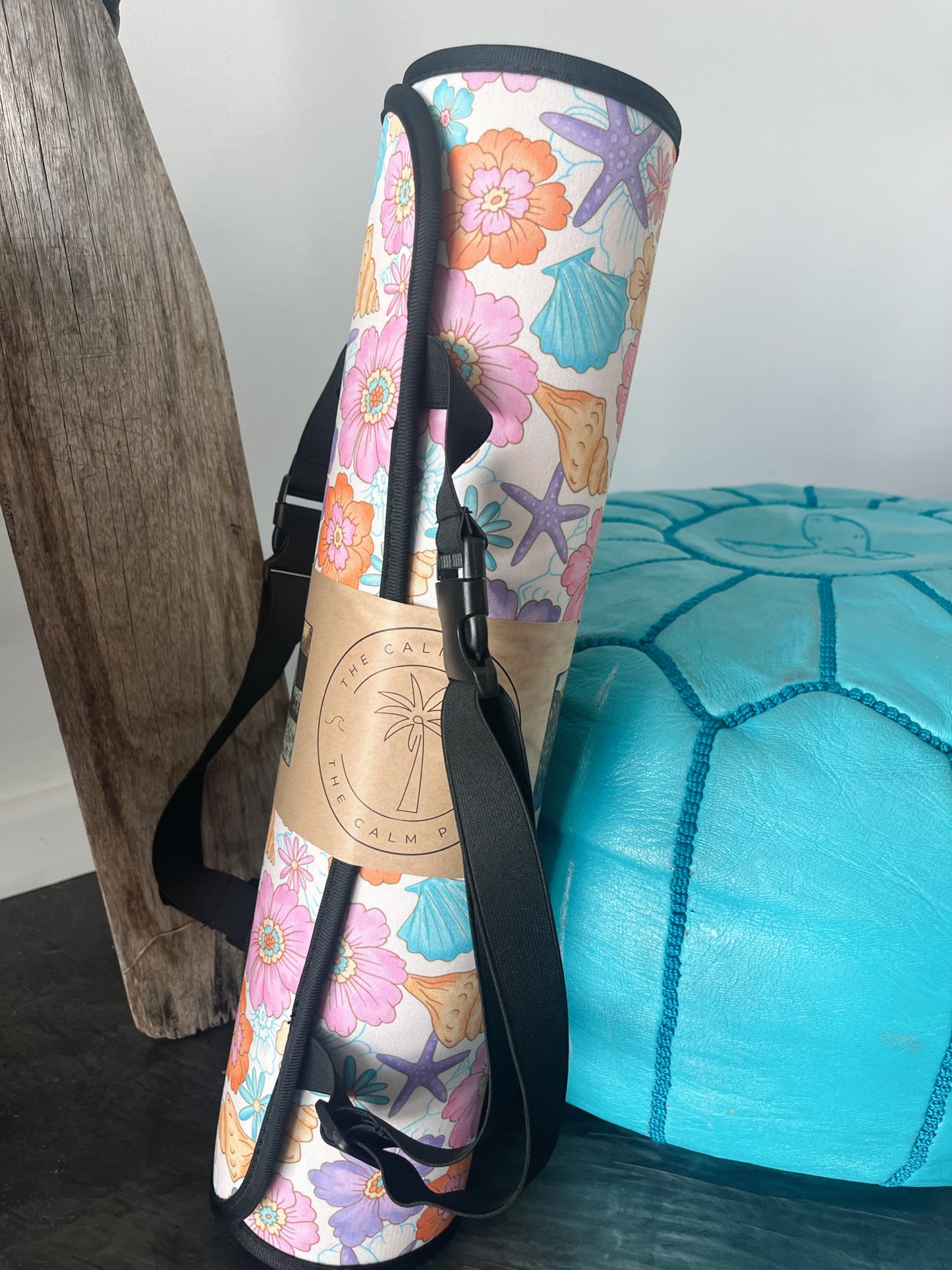 Pastel floral and seashell print Car Seat Cover rolled up. Roll it up for compact storage