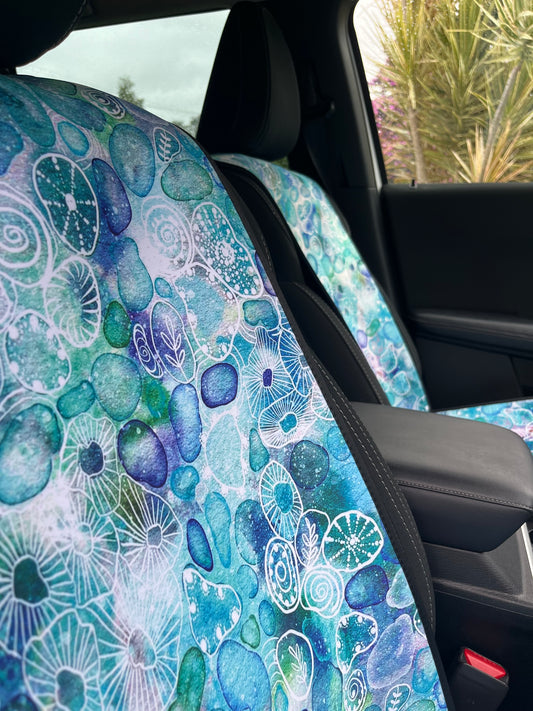 Seaglass print in Aqua tones. Shown on a car seat. Easy to install