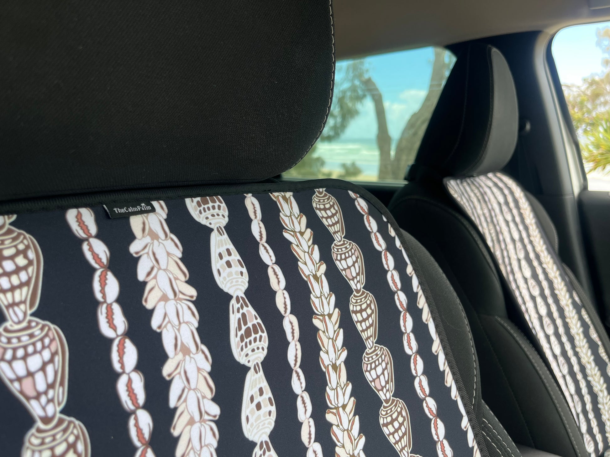 Seashell Lei patterned Car Seat Covers in the car. Black and white in colour