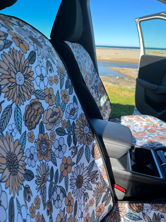 Yellow, green and white floral print on neoprene Car Seat Covers. Shown on the front seats of a car. Easy to install and clean