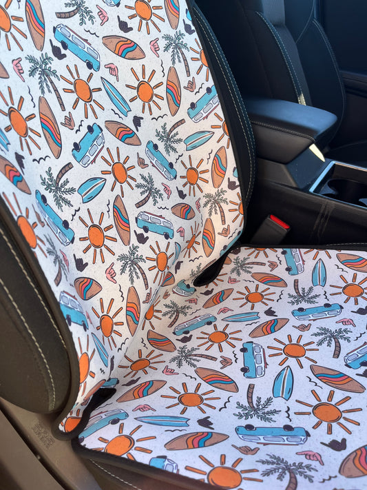 Combi vans, suns, palm trees, and surfboard print in tans/browns, yellow and aqua. Shown on car seat