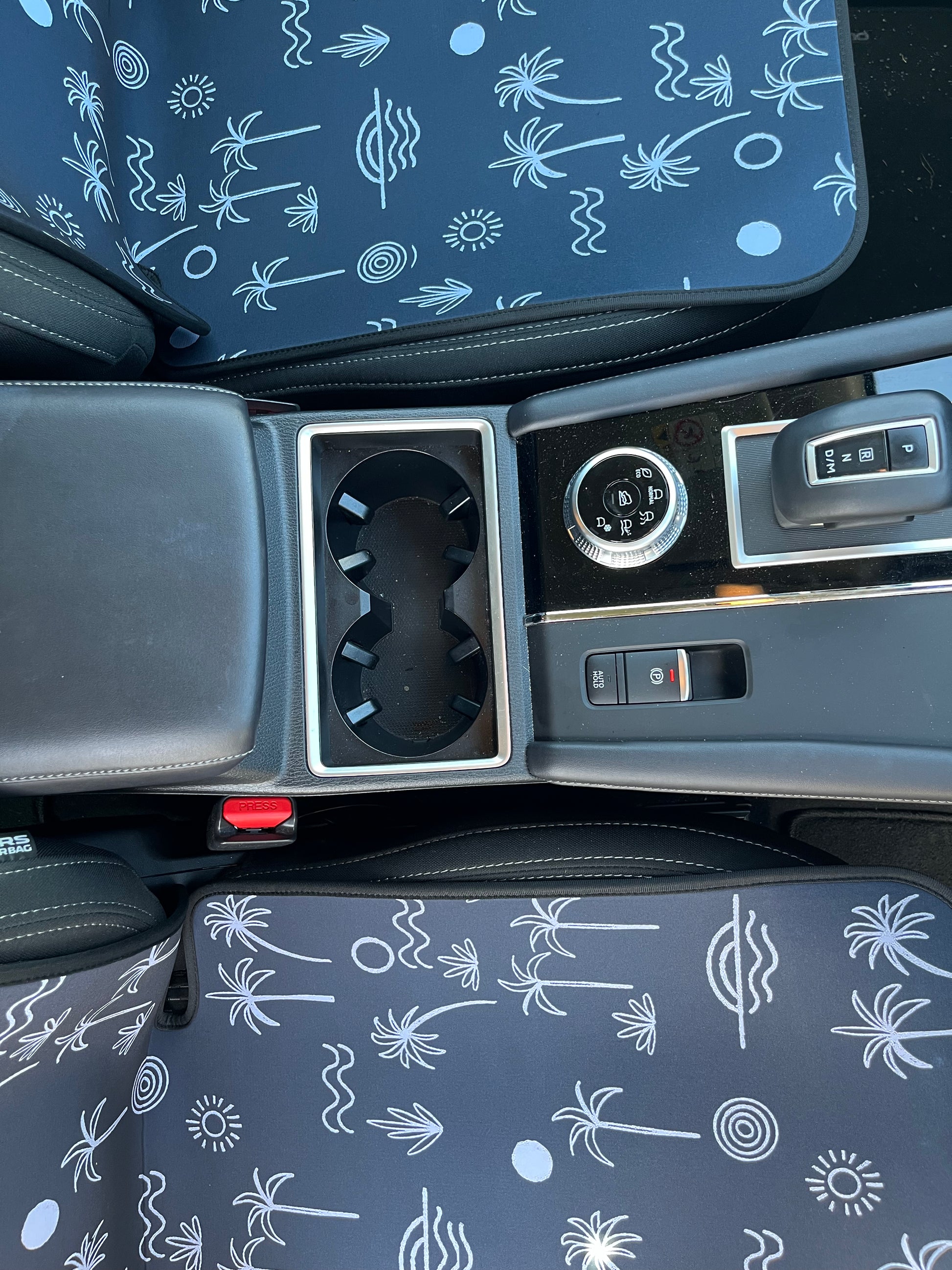 Black and white Palm tree print. Set of Seat Covers shown on the front seats of a car. Easy to install